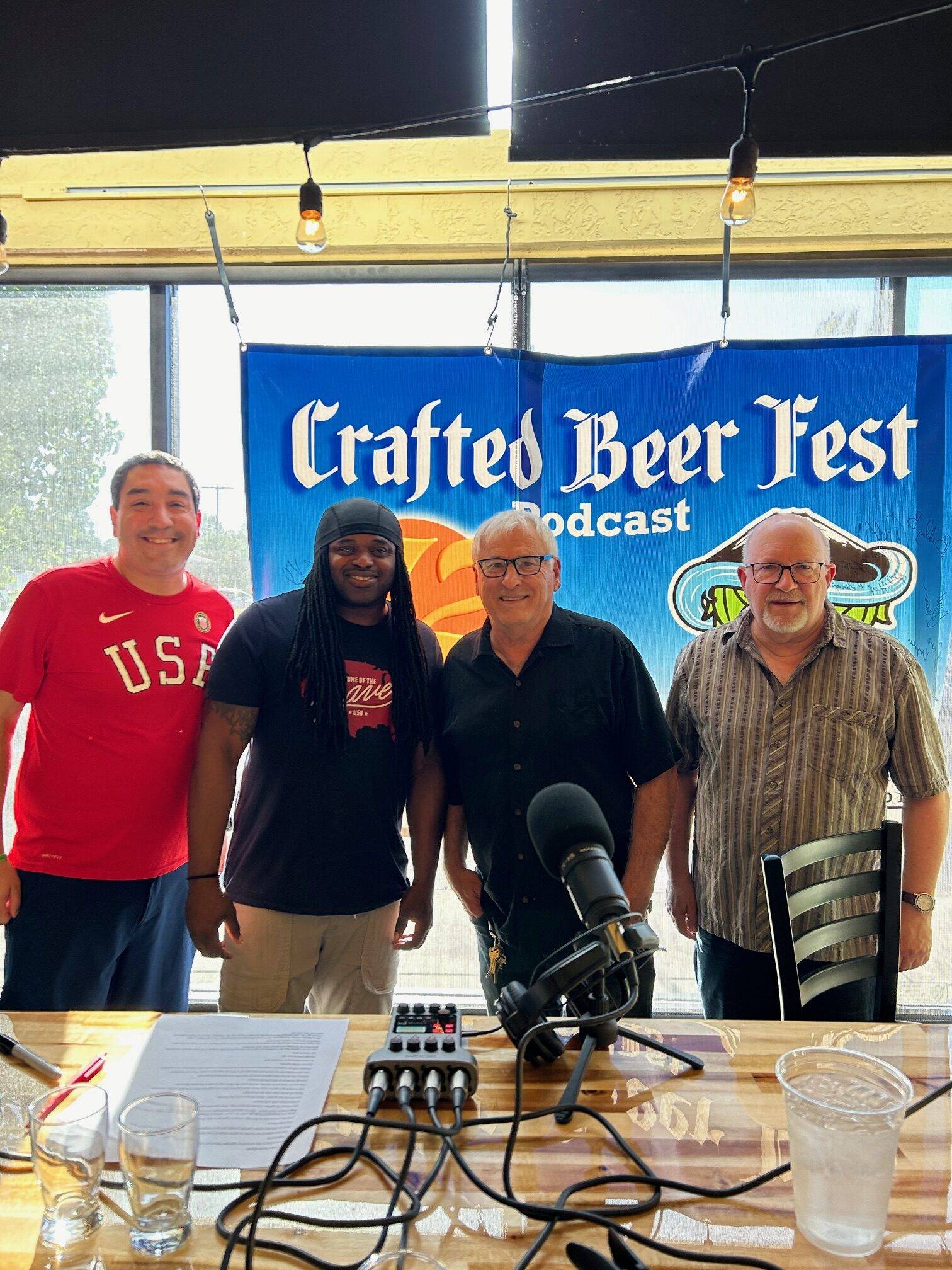 Marc Roland & Jim Seeks talk to crafted Beerfest podcast standing in front the crafted podcast banner